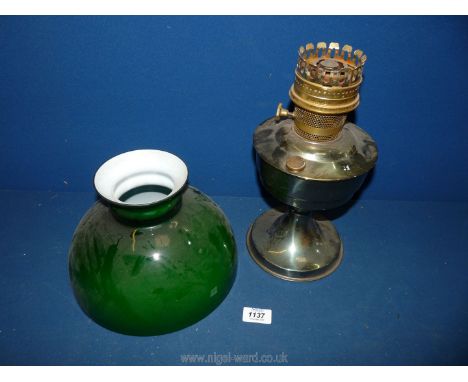 A metal Oil Lamp with green shade.