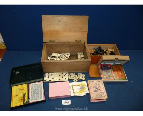 A quantity of wooden Chess pieces, old Dominoes in two different sizes and quantity of playing cards including Happy Families