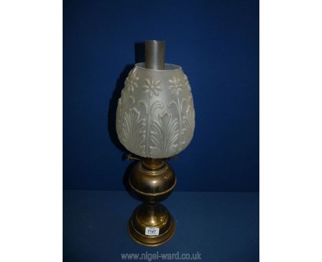 A reproduction brass oil lamp with frosted decorative shade. 21" tall.
