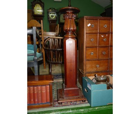 A heavy Mahogany lamp table/jardinere stand having a chamfered square pillar with turned and foliage detail upper feature, th