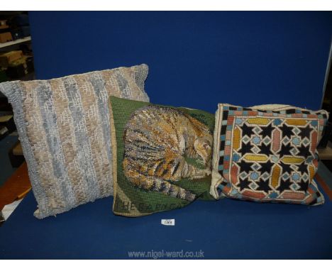 Three tapestry cushions, one of a cat.