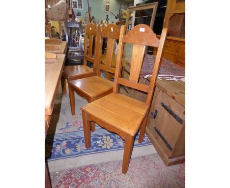 A matching set of eight light Oak Dining Chairs having solid seats, tapering square legs and tapering back splats.