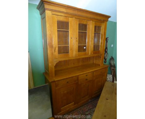 A matching contemporary peg joyned light Oak enclosed ''Exigence'' Dresser, the upper portion with three glazed doors, the ba
