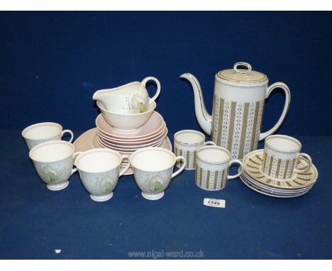 A Susie Cooper part tea set in 'Persia' pattern to include teapot, three cups, five saucers, and a Wedgwood 'Susie Cooper' pa