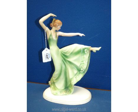 A continental china figure of an Art Deco lady dancing in green dress, possibly German, no: E50 to base, 10" tall (damage to 