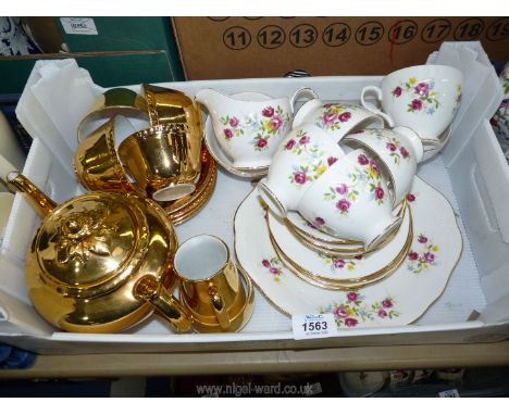 A gold Royal Worcester tea set and a Queen Anne floral part tea set, including six cups, five saucers- one cracked, six tea p