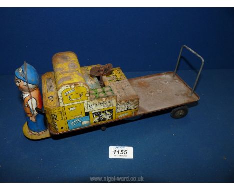 A clockwork tin plate Toy in the form of station porter with trolley made in Britain by Wells Brimtoy, (toy turns and bells r