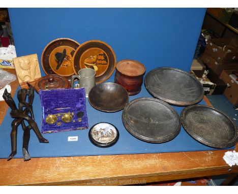 A quantity of treen including bowls, wall plaques, carved flower, container and lid, and a cased set of postal scales with we