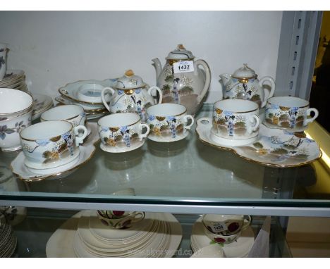 An oriental Teaset with six cups and five saucers, small teapot, sugar bowl and lidded milk jug.