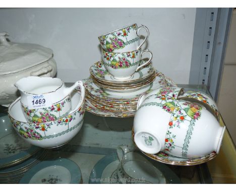 A part 'Diamond china' part tea set with green leaf, rose, and colourful fruit pattern on white ground with gold coloured edg