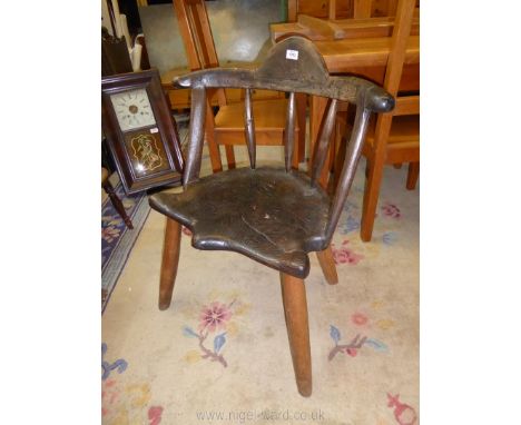 A collectable early Primitive and rustic comb back Chair having a solid Elm shaped seat, five back supports and humped top ra