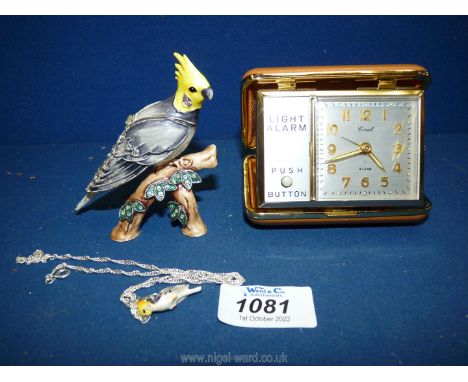 A boxed 'Hidden Treasure of Cockatoo' with miniature pendant inside head, plus a travel alarm with light.