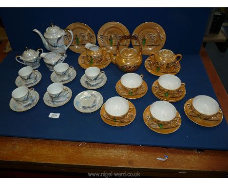 Two part oriental tea sets one with scenes of dragons, both including teapots, cups, and saucers, etc (some chips.)