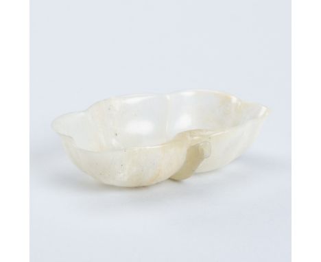 A MUGHAL-STYLE JADE 'LOTUS' WASHER, QING DYNASTYChina, 18th-19th century. Delicately and thinly carved in the form of a curve