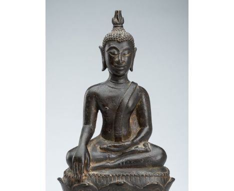 A BRONZE FIGURE OF BUDDHA SHAKYAMUNILaos, 16th-17th century. Seated in dhyanasana on a lotus pedestal supported by a plinth b