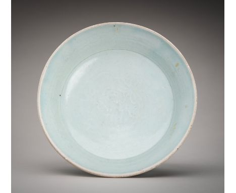 A QINGBAI GLAZED PORCELAIN DISH, YUAN DYNASTYChina, Yuan Dynasty (1279-1368). The dish with deep sides and supported on a sho