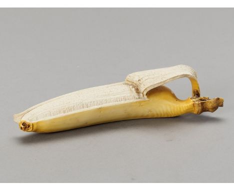 A STAINED IVORY 'TROMPE-L'OEIL' OKIMONO OF A BANANAJapan, Meiji period (1868-1912)Carved as a half-peeled banana, a section o