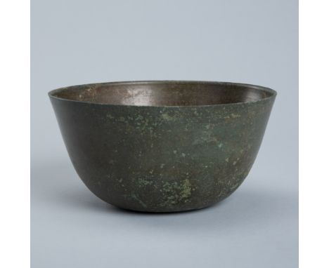 A BRONZE BOWL, ANGKOR PERIOD, 10TH-12TH CENTURYKhmer Empire. Thinly cast, supported on a flat base with rounded sides and a r