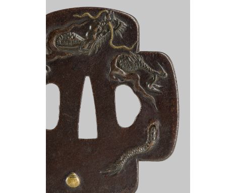 AN IRON TSUBA WITH A DRAGON CHASING A TAMAUnsignedJapan, 18th century, Edo period (1615-1868)The iron tsuba of jujimokkogata 