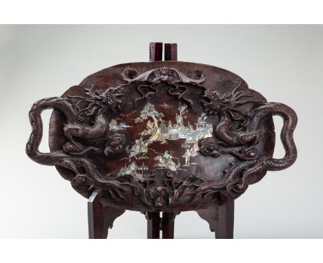 A LARGE MOTHER-OF-PEARL INLAID WOOD TRAY DEPICTING JOUSTING WARRIORSVietnam, 19th century. Carved in high relief with two lar