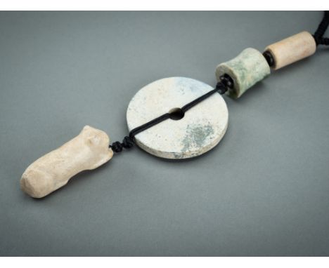 A PENDANT WITH JADE AND HARDSTONE ORNAMENTS, QINGChina, Qing Dynasty (1644-1912) or earlier. Comprising a stone figure of a r