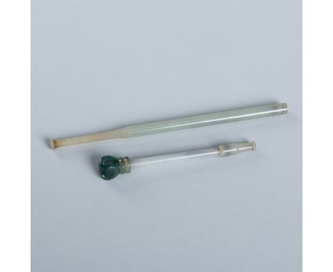 A GROUP OF TWO JADE CIGARETTE HOLDERS, c. 1920sChina, Republic period (1912-1949). The first of typical form, the translucent