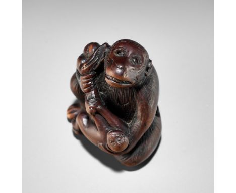 A HUMOROUS WOOD NETSUKE OF TWO MONKEYS AND PEACH, ATTRIBUTED TO MITSUHARUAttributed to Mitsuharu, unsignedJapan, Kyoto, late 