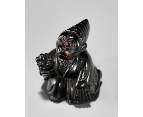 A CHARMING KUROGAKI (BLACK PERSIMMON) WOOD NETSUKE OF A MONKEY AS A SAMBASO DANCERUnsignedJapan, first half of 19th century, 