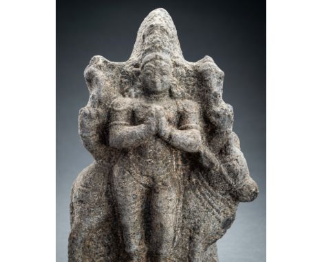 A GRANITE FIGURE OF ADHIKARA NANDI, 15th CENTURYIndia, 15th century or earlier. The granite statue depicting Nandi in both hu