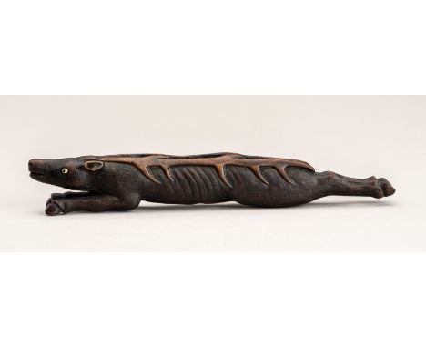 A VERY LARGE WOOD SASHI NETSUKE OF A DEERJapan, 20th centuryCarved as an elongated deer, its hind legs stretched out, its fro