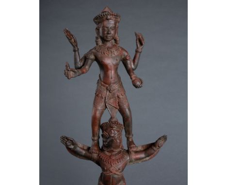 A LARGE BRONZE OF FIGURE OF VISHNU AND GARUDA, KHMER STYLECambodia or Thailand, 20th century. The four-armed Vishnu stands on