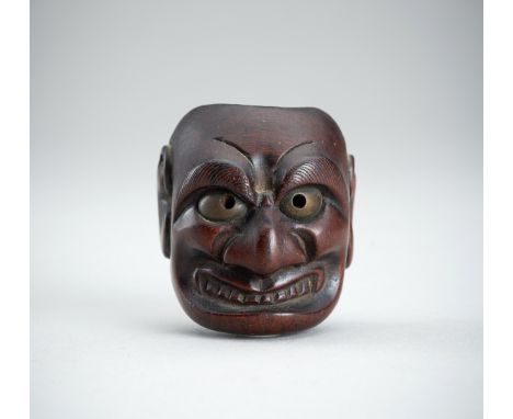 DEME UMAN: A WOOD MASK NETSUKE OF BUAKU, EDO PERIODBy Deme Uman, signed Deme Uman 出目右滿 and Tenkaichi 天下一 Japan, Edo (Tokyo), 