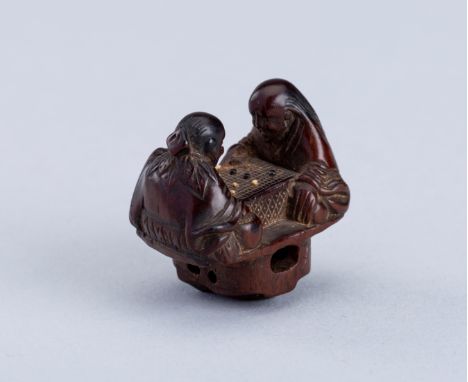 INTERIOR OF A WOOD KARAKURI NETSUKE WITH TWO IMMORTALS PLAYING SUGOROKU, EDO PERIODJapan, 19th century, Edo period (1615-1868