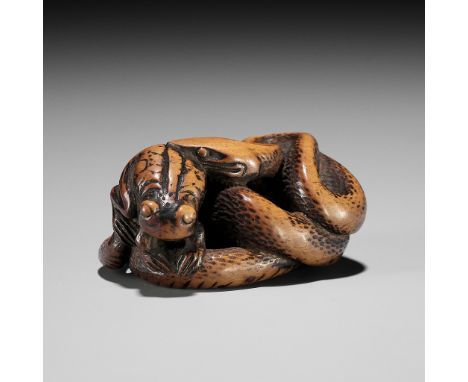 AN EARLY WOOD NETSUKE OF A SNAKE AND FROGUnsigned Japan, late 18th century, Edo period (1615-1868)Boldly carved as a snake co
