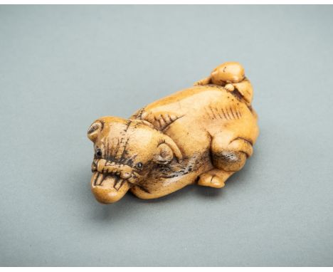 AN ANTLER NETSUKE OF A RECUMBENT OX WITH BOY, EDO PERIODJapan, 19th century, Edo period (1615-1868)Well carved, depicting a r