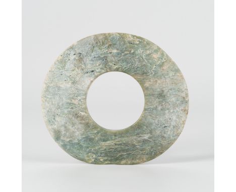 A JADE BI DISC, LIANGZHU CULTUREChina, 3rd millennium BC. Of somewhat irregular thickness, carved from a mottled celadon jade