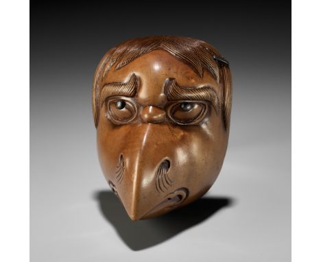 GYOKUIN: A SUPERB AND LARGE WOOD MASK NETSUKE OF A LAMENTING KARASU TENGUBy Gyokuin, signed Gyokuin 玉因Japan, 18th century, Ed