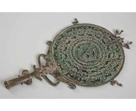 A BRONZE 'PROCESSION OF ANIMALS' MIRRORSoutheast Asia, 17th century or earlier. The back of the mirror cast with a central zo
