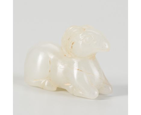 A JADE 'RAM' BEADChina, late Qing dynasty (1644-1912). Modeled as a recumbent ram, the hooves folded close to each other with