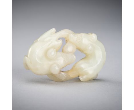 A PALE CELADON JADE 'DOUBLE BADGER' GROUP, QING DYNASTYChina, Qing dynasty (1644-1912). The recumbent bodies gracefully coile