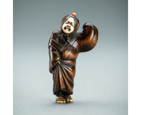 AN INLAID WOOD NETSUKE OF A COMIC PERFORMER, EDO PERIODJapan, 19th century, Edo period (1615-1868)  The finely carved antler 