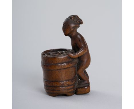 TAMIYOSHI: A WOOD NETSUKE OF A WOMAN AND A HINOKI OFURO (BATHING BARREL)By Tamiyoshi, signed TamiyoshiJapan, 19th centuryThe 