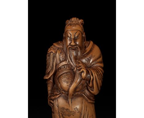 YOSHITOSHI: A SUPERB AND LARGE WOOD NETSUKE OF KAN'U STROKING HIS BEARDBy Yoshitoshi, signed Yoshitoshi 慶寿Japan, late 18th to