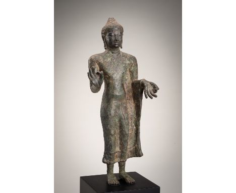 A BRONZE FIGURE OF BUDDHA, MON DVARAVATI STYLEThailand, 18th century or later. Finely modeled standing in a dynamic pose, rem