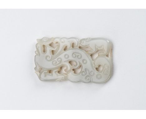 A CELADON-WHITE JADE 'DRAGON AND TAPIR' PENDANT, QING DYNASTYChina 18th to 19th century. Of flattened rectangular shape with 