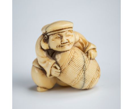 A CHARMING IVORY NETSUKE OF DAIKOKO LIFTING A RICE BALEUnsignedJapan, 18th centuryThe God of Wealth and Agriculture, Daikoku,