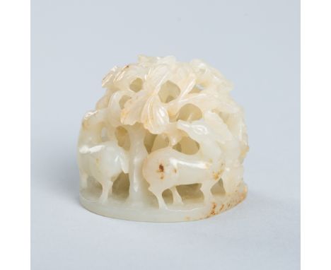 AN OPENWORK JADE HAT FINIAL WITH DEER, QING DYNASTYChina, Qing Dynasty (1644-1912). Densely carved and pierced with four deer