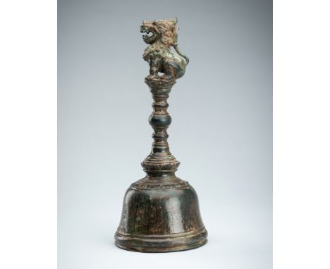 A BRONZE JAVANESE 'LION' TEMPLE BELLJava, 15th century or later. The domed bell flaring towards the ringed lip, surmounted by