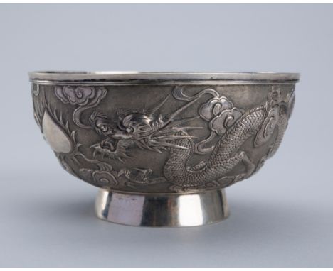 A FINE SILVER REPOUSSE 'DRAGON' BOWL, c. 1920sChina. The deep bowl with rounded sides rising from a circular foot, finely emb