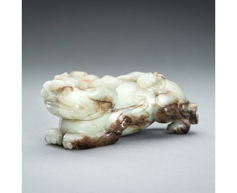 A CELADON AND RUSSET JADE `BIXIEÂ´, QINGChina, Qing Dynasty (1644-1912). Boldly cast as a crouching bixie with bifurcated tai